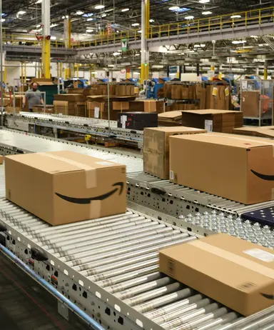 Parcels moving along a conveyor in an Amazon fulfilment centre